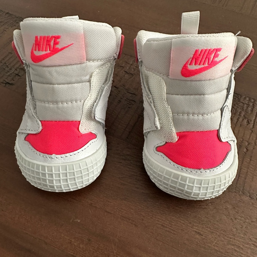 Hot pink and white baby Air Jordan sneakers